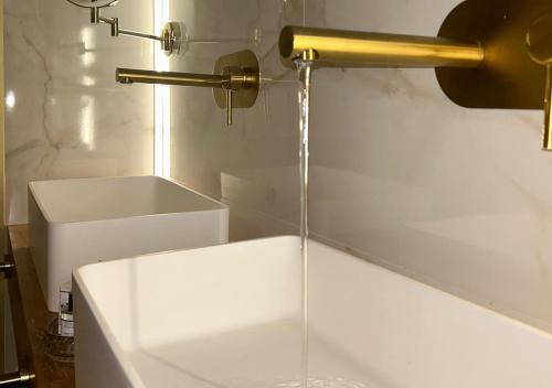 a bath tub with a water fountain in a bathroom at Hospedium Hotel Barómetro de Camariñas in Camariñas