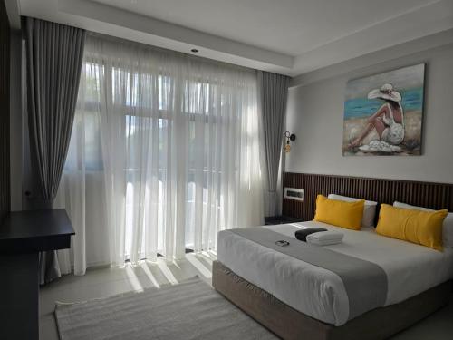 a bedroom with a bed and a large window at Oloisiri Namanga Hotel in Namanga