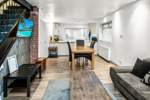 a living room with a table and a couch at Central Manchester Family-Friendly Home with Free Parking and Workspace in Manchester