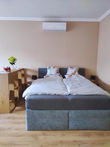 a bedroom with a bed with a blue foot board at Lilibella apartman in Miskolc