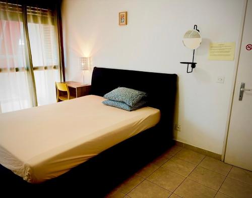 a bedroom with a bed with a pillow on it at Lugano 33A - No Bikes - Self check-in - no reception in Lugano