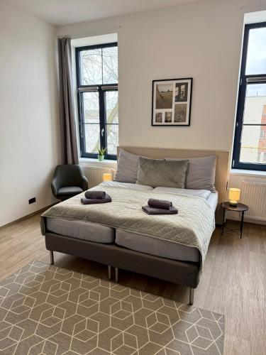 a bedroom with a bed with two towels on it at Penzion Klas in Měřín