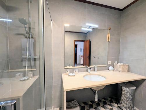 a bathroom with a sink and a shower at 06 Sra da Rocha - Casas & Papeis in Porches