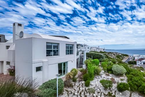 a white house with a view of the ocean at 43 Artemis, Langebaan, 8-sleeper in Langebaan