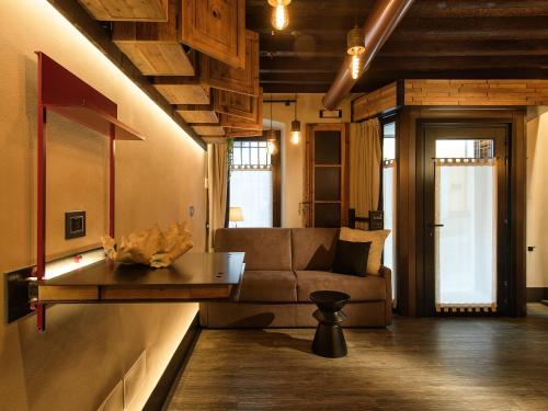 a living room with a couch and a table at La Vite Apartments by Queen Gallery in Desenzano del Garda