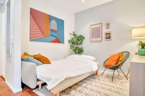 a bedroom with a bed and a chair at Heimby - Studio w Free parking in Bergen