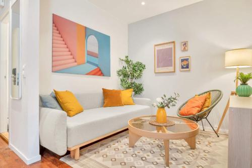 a living room with a couch and a table at Heimby - Studio w Free parking in Bergen