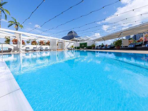 a large swimming pool with blue water at Pullman Reef Hotel Casino in Cairns