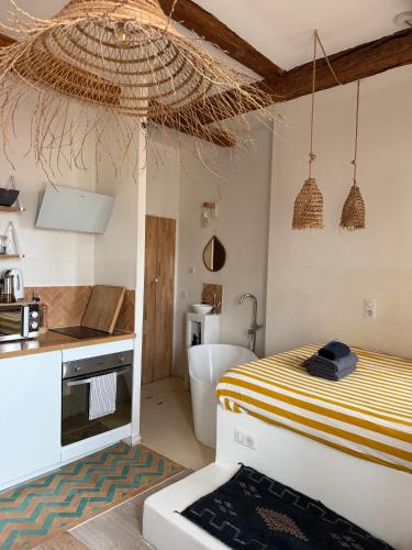 a bedroom with a bed and a sink and a tub at LaFrenchCasa Canebière in Marseille