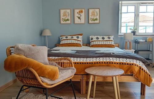 a bedroom with a large bed with two chairs at Ethic Surf House in Ferrel