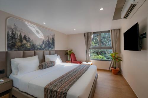 a bedroom with a large bed and a large window at Hotel Shivashish in Ahmedabad