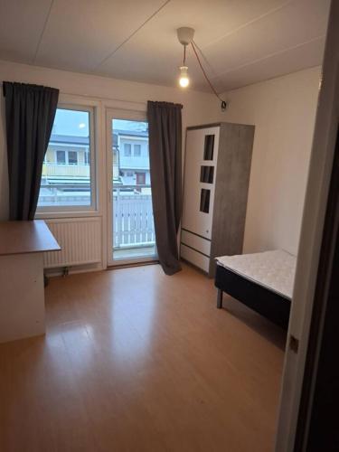 a room with a bed and a large window at Workers Stay - Construction Worker Housing in Gothenburg