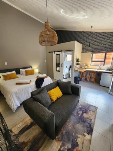 a living room with a couch and a bed at 14 on Maroela in Polokwane