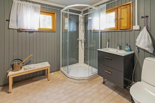 a bathroom with a shower and a sink at Villa Lepola Sauna Suite in Rovaniemi