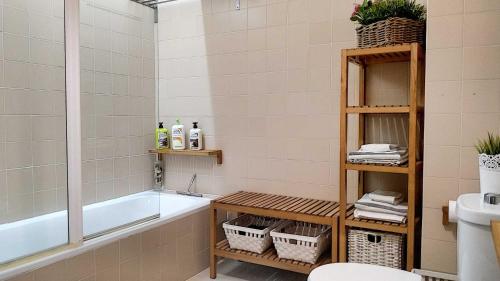 a bathroom with a tub and a toilet and a sink at Porto Terrace in Espinho
