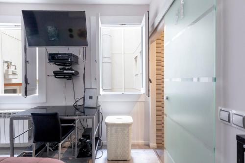 a kitchen with a table and chairs and a window at Malasaña & Plaza España in Madrid