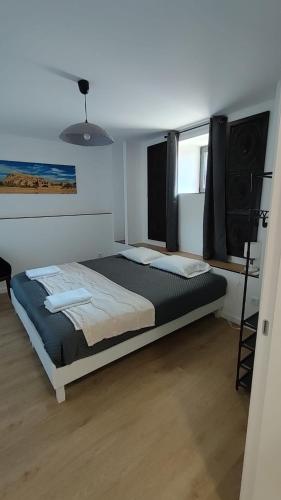 a bedroom with a large bed with a speaker at Casas de Correndelos in Ponte de Lima