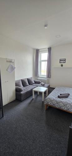 a living room with a couch and a table at Pension U Johnů in Petrovice