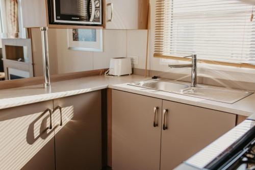 a kitchen with a sink and a counter top at Lower Cliff 19 in Easton