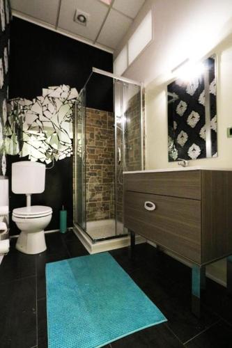 a bathroom with a shower and a toilet and a sink at K-Smart in Catania