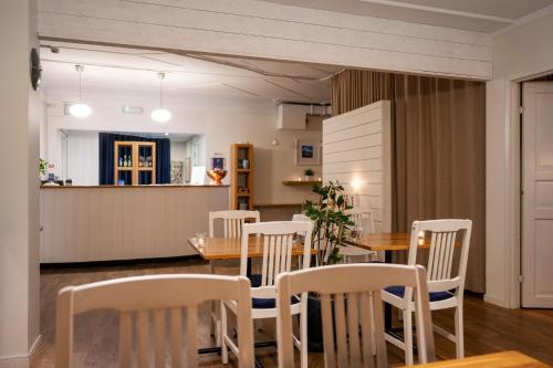 a dining room and kitchen with a table and chairs at Port Hotel Apartments in Karlshamn