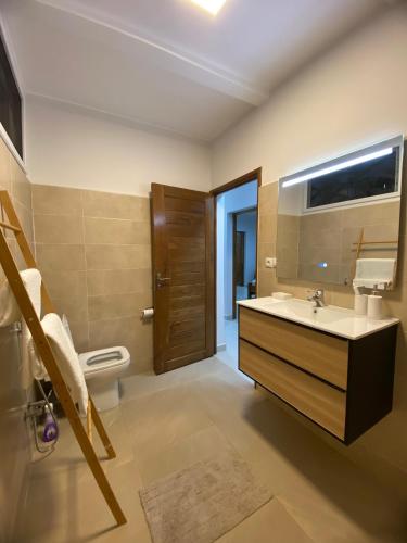 a bathroom with a sink and a toilet at Hasoa Villa in Morondava