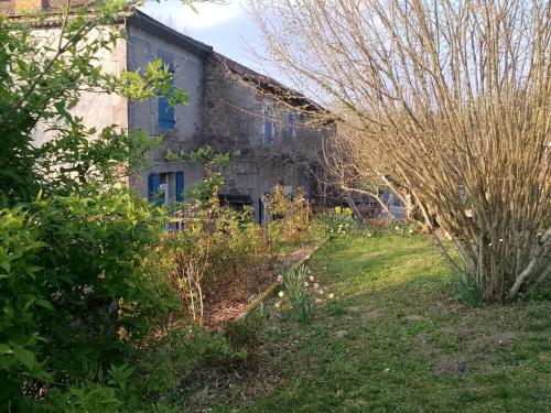 an old house with a garden in front of it at Lacour in Augignac