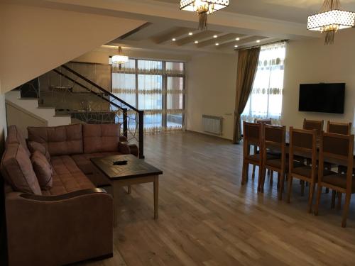 a living room with a couch and a dining room at Deer Villa in Tsaghkadzor