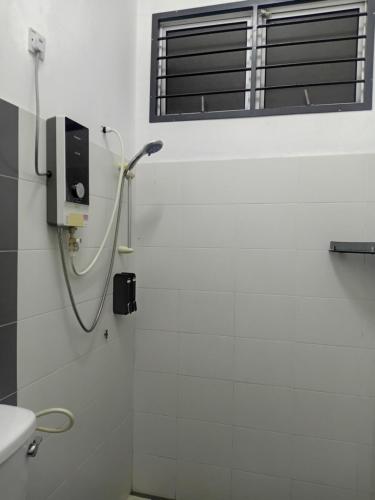 a bathroom with a shower and a window at KTL Homestay in Kuantan