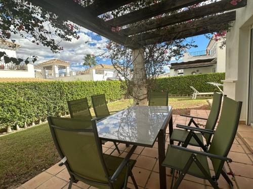a glass table and chairs on a patio at Spacious Villa - DN32LT in Torre-Pacheco