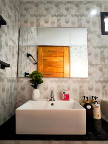 a white sink in a bathroom with a mirror at De Napa - Private Homestay in Ban Mae Na