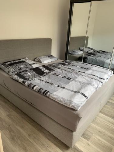 a bed sitting in a room with a mirror at Appartement in Bad Kreuznach