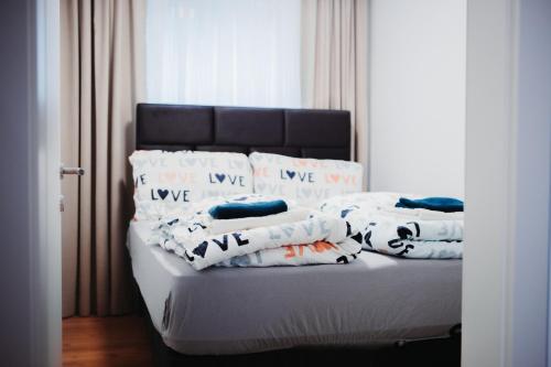 a bed with some pillows on top of it at Haus Edelweiss in Tarrenz