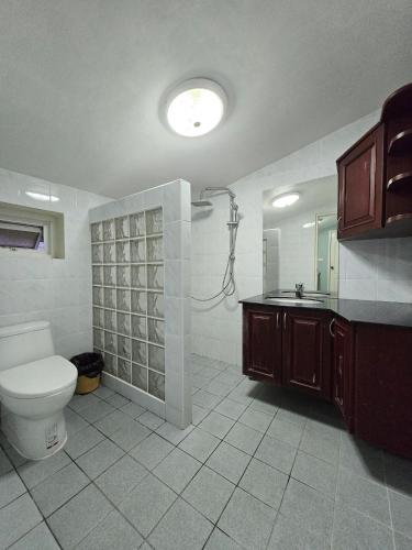 a bathroom with a shower and a toilet and a sink at Townhome 44 in Ban Nong Pru