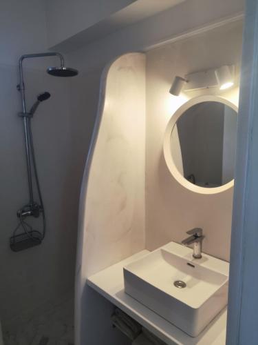 a white bathroom with a sink and a mirror at Villa Rizia in Kolymbia