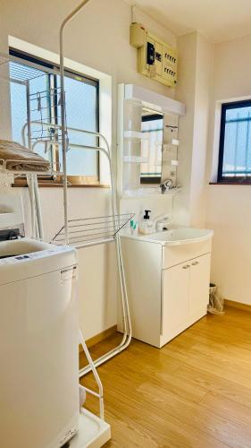 a hospital room with a sink and a mirror at 街角TheStreetCorner in Noritake-Shinmachi