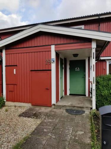 a red garage with green and red doors at Workers Stay - Temporary House Gothenburg in Gothenburg