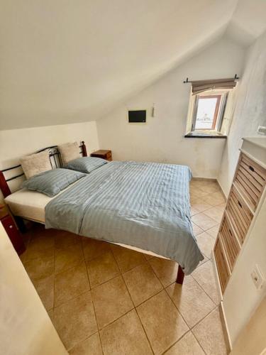 a bedroom with a large bed in a room at Family Apartman Baška in Baška