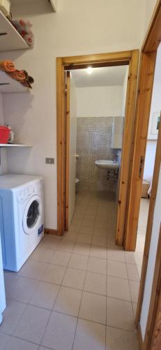 a kitchen with a washer and dryer in a room at Best Holidays Pineta in Marcelli