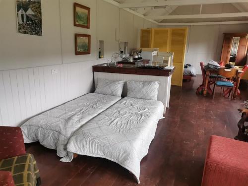 a bedroom with a bed in a room at Rivendell Forest Retreat in Wilderness