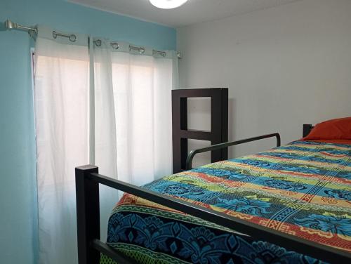 a bedroom with a bed and a window at Casa completa equipada para cualquier ocasión in Tezoyuca