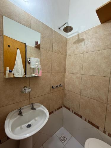 a bathroom with a sink and a mirror at Casita de Ceci in Pilar
