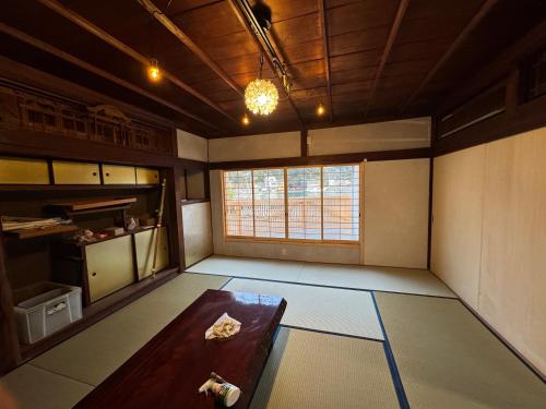 a living room with a table and a window at 海と鉄 1日1組限定の宿 in Sukumo