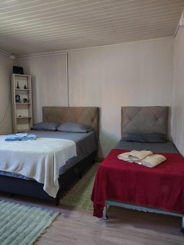two beds sitting next to each other in a room at Condomínio Central Casa Luíza in Uruguaiana
