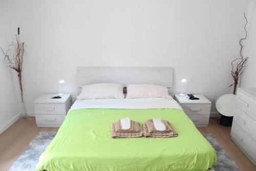 a bedroom with a green bed with two towels on it at La Vinella in Lamezia Terme