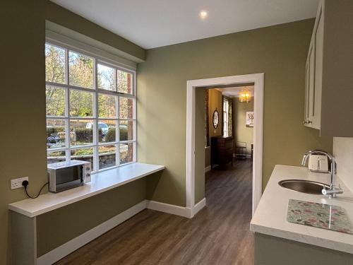 a kitchen with a sink and a window at Bleaton Hallet House Riverside Escape in Kingseat