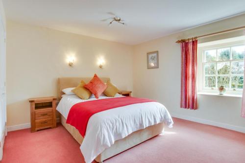 a bedroom with a bed with a red carpet at 3 Bed in Caldbergh oc-ds911 in Caldbergh