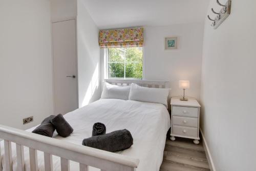 a white bedroom with a large bed with a window at 2 Bed in Kingsbridge oc-bc3188 in Kingsbridge