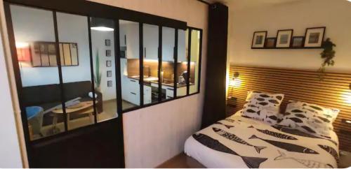a bedroom with a bed and a mirror at Superbe appartement face à la mer à Erquy in Erquy