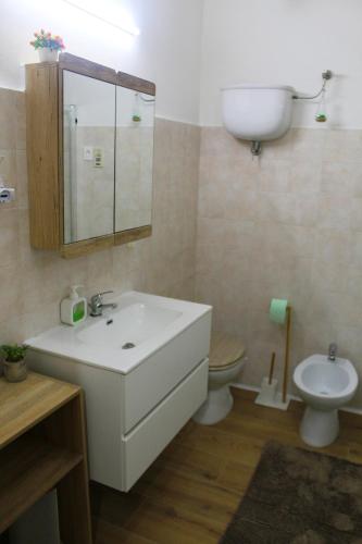 a bathroom with a sink and a toilet at La Vinella in Lamezia Terme